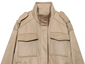 Detail of khaki faux suede jacket with epaulettes and symmetrical flap pockets