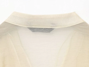 Detailed view of back neckline and premium texture on cream chiffon blouse