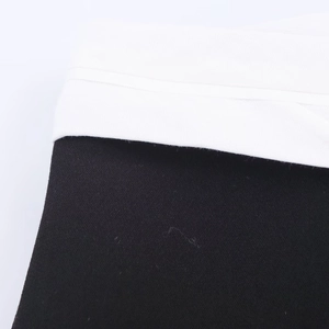 Macro shot showing contrasting black and white fabric textures with fine diagonal twill weaving