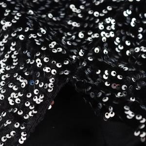 Elegant asymmetrical evening dress featuring high-density silver sequins on black fabric