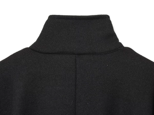Detailed view of high-quality black wool blend fabric texture and collar stitching