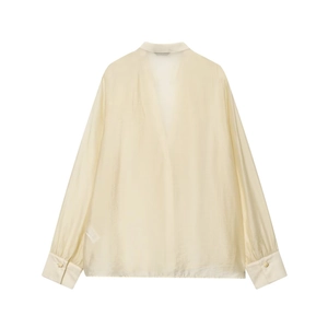 Elegant cream ruffled V-neck chiffon blouse with wide cuffs and gold hardware details