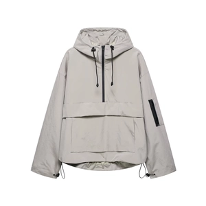Macro detail of hooded anorak jacket showing front flap pocket and half-zip collar