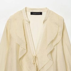 Elegant cream ruffled v-neck chiffon blouse with tie front and lightweight texture