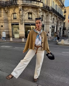 Chic women's camel suede aviator jacket styled with cream pants and leopard flats