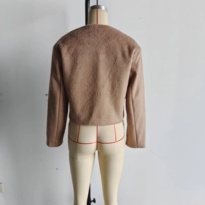 Back view of a cropped brown wool blend jacket showing soft plush texture on a mannequin