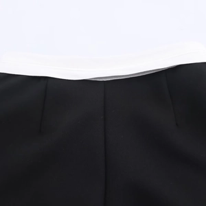Detail view of contrast waist panel and stitching on black and white skort