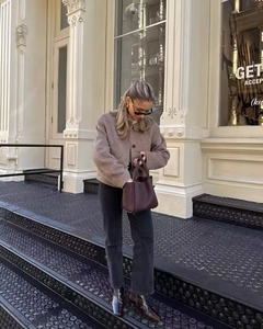 Street style view of a brown wool blend cropped jacket paired with dark brown leather bag
