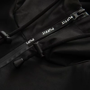 Detail of waterproof zipper with white PUFFIT text and black adjustable drawstrings