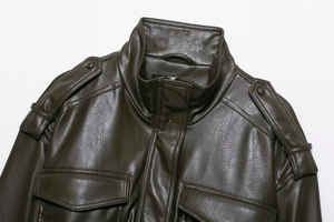 Détail d'une veste en cuir vert olive foncé avec épaulettes et col montant chic