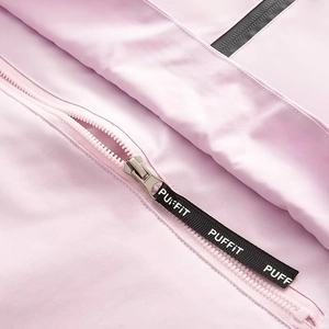 Detailed close-up of a pink windbreaker zipper with a black PUFFIT logo puller