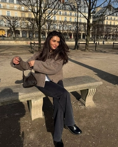 Close-up of a brown wool blend cardigan styled with grey wide-leg jeans and a handbag