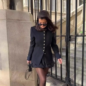 Chic women's black slim-fit blazer with stand collar and gold buttons outdoor view