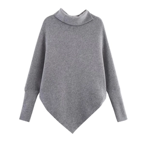 Detailed view of grey batwing sleeve knit sweater with turtleneck and irregular hem