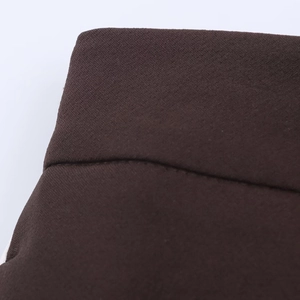 Macro detail of dark coffee woven fabric texture and stitching on waistband