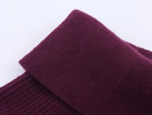 Macro view of burgundy ribbed knit texture with soft core-spun yarn finish detail