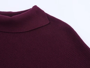 Macro detail of dark purple ribbed knit texture on the neckline and shoulder area