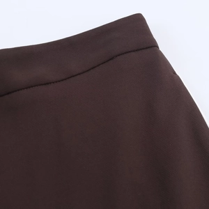 Detail of high-waist dark brown pants with side stripe and precise sewing