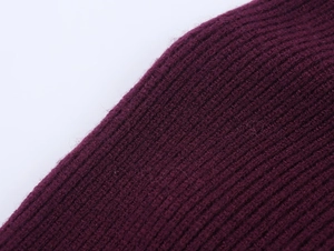 Close-up of ribbed knit texture on a dark burgundy sweater with elastic core yarn fabric