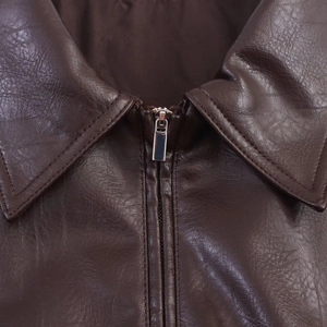 Detailed close-up of dark brown faux leather texture and metallic zipper on aviator jacket