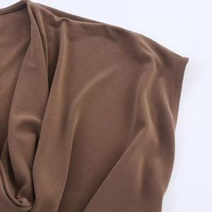 Close-up of fine stitching and textured dark coffee fabric on elegant dress