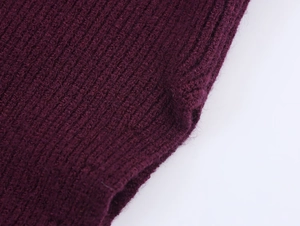 Macro shot of vertical rib-knit texture and seam details on burgundy knitwear