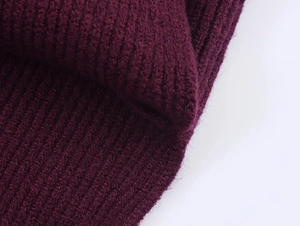 Macro shot of heavy-weight burgundy ribbed knit texture on the irregular batwing sweater
