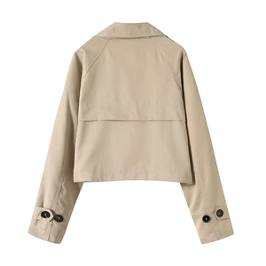 Rear view detail of khaki cropped trench coat showing back storm flap and raglan sleeves