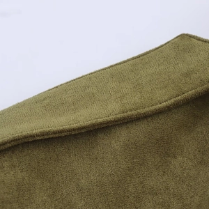Detailed macro view showing olive green faux suede fabric texture and double-stitched seams