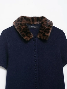 Detailed view of dark blue knit cardigan with leopard print faux fur collar and buttons