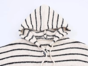 Detail of striped knit cardigan hoodie with black button and cream drawstring