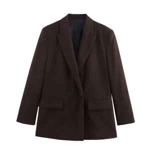 Close-up of chocolate brown double-breasted blazer with structured shoulders and flap pockets