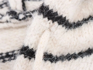 Macro shot of striped knit cardigan fabric showing soft mohair texture and wool fibers