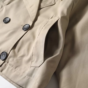 Classic beige short trench coat with double-breasted buttons and side pockets