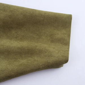 Detail of olive green faux suede fabric with soft matte texture for bomber jacket