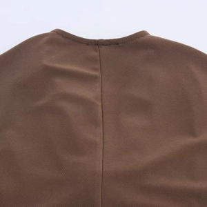 Close-up of the elegant dark brown dress featuring a round neckline and fine twill texture