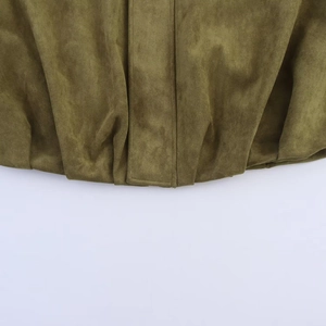 Detailed macro view of olive green suede fabric texture on a pilot jacket hem