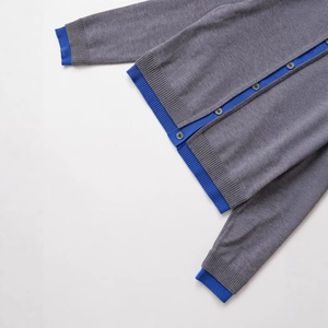 Women's grey knit cardigan with blue ribbed trim and button-front closure in flat lay view