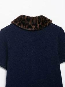 Detail of short sleeve navy knit cardigan with leopard print faux fur collar trim