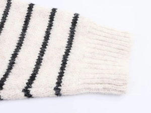 Detailed macro view of fuzzy knit striped sweater cuffs with ribbed texture details