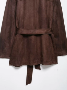 Detail of dark brown faux suede jacket back with stitching and matching waist belt