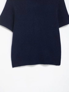 Detailed view of dark blue short sleeve knit cardigan with animal print neckline
