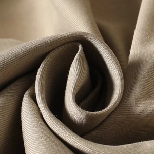 Detailed close-up of khaki high-density twill fabric showing premium texture and weaving