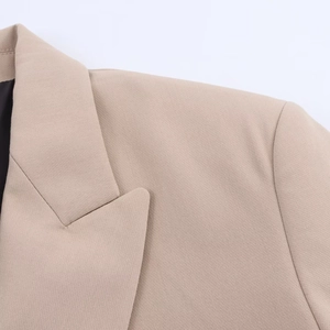Detail of notched lapel and high-density woven fabric on beige double-breasted blazer