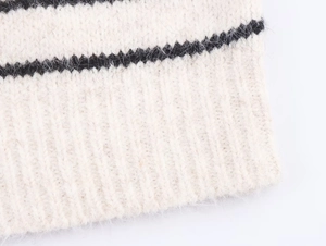 Close-up of fluffy striped knit texture with soft mohair yarn and ribbed cuffs