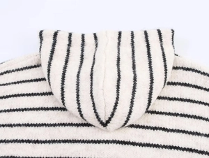 Detail of hood and horizontal striped texture on the oversized knitted cardigan sweater
