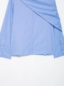 Detail view of blue striped shirt cuffs and hem with white buttons and fine texture