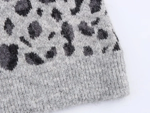Detailed macro view of soft leopard jacquard knit texture and ribbed cuff finishing