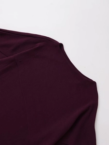 Close-up of dark purple knit fabric showing fine texture and durable shoulder stitching
