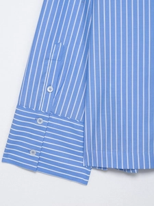 Detail of blue and white striped shirt cuff with double white buttons and neat stitching
